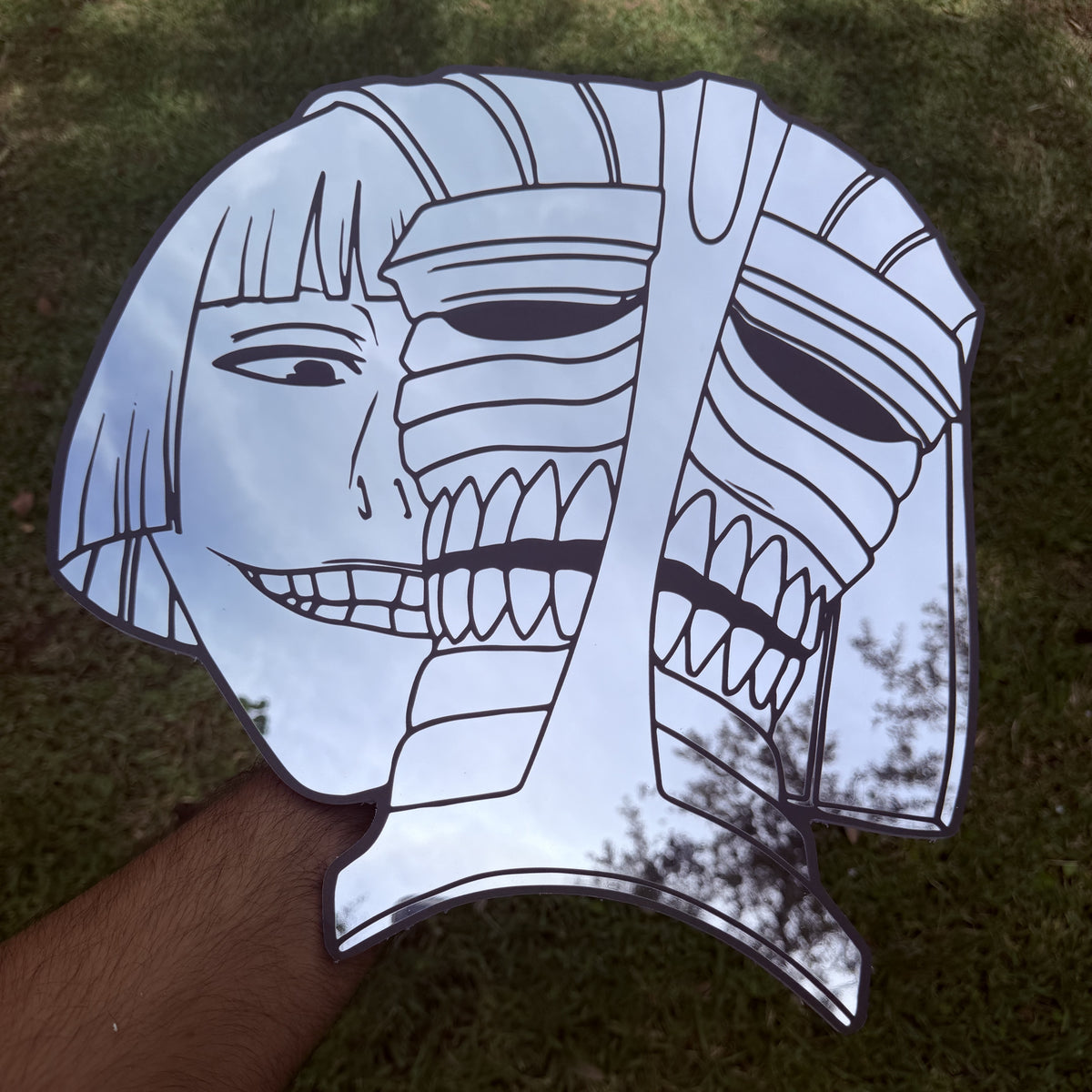 The Masked Captain Mirror, Bleach wall mirror, held in hand for scale